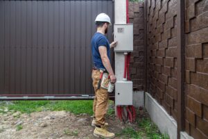 electrician-builder-work-examines-cable-connection-electrical-line-fuselage-industrial-switchboard-professional-overalls-with-electrician-s-tool_169016-7336
