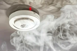 image of electrician installing smoke detector