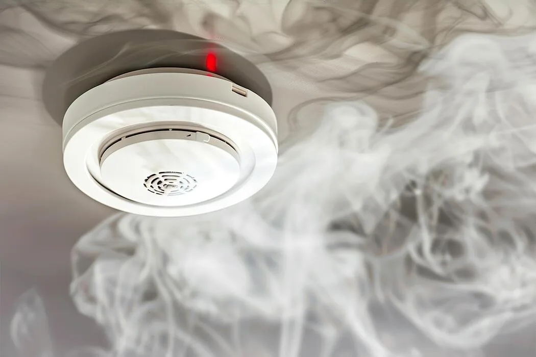image of electrician installing smoke detector & fire alarm installation